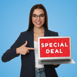 Image of Special deal. Young woman pointing at laptop on light blue background