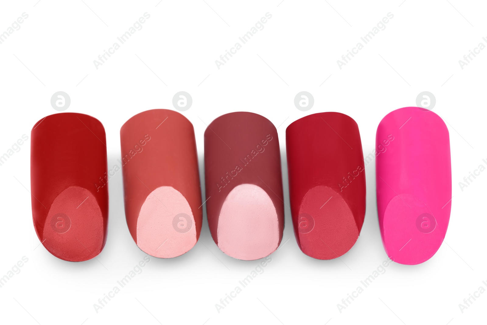 Photo of Many different bright lipsticks on white background