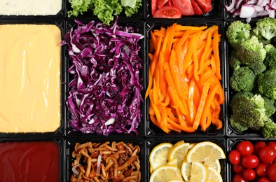 Salad bar with different fresh ingredients as background, top view