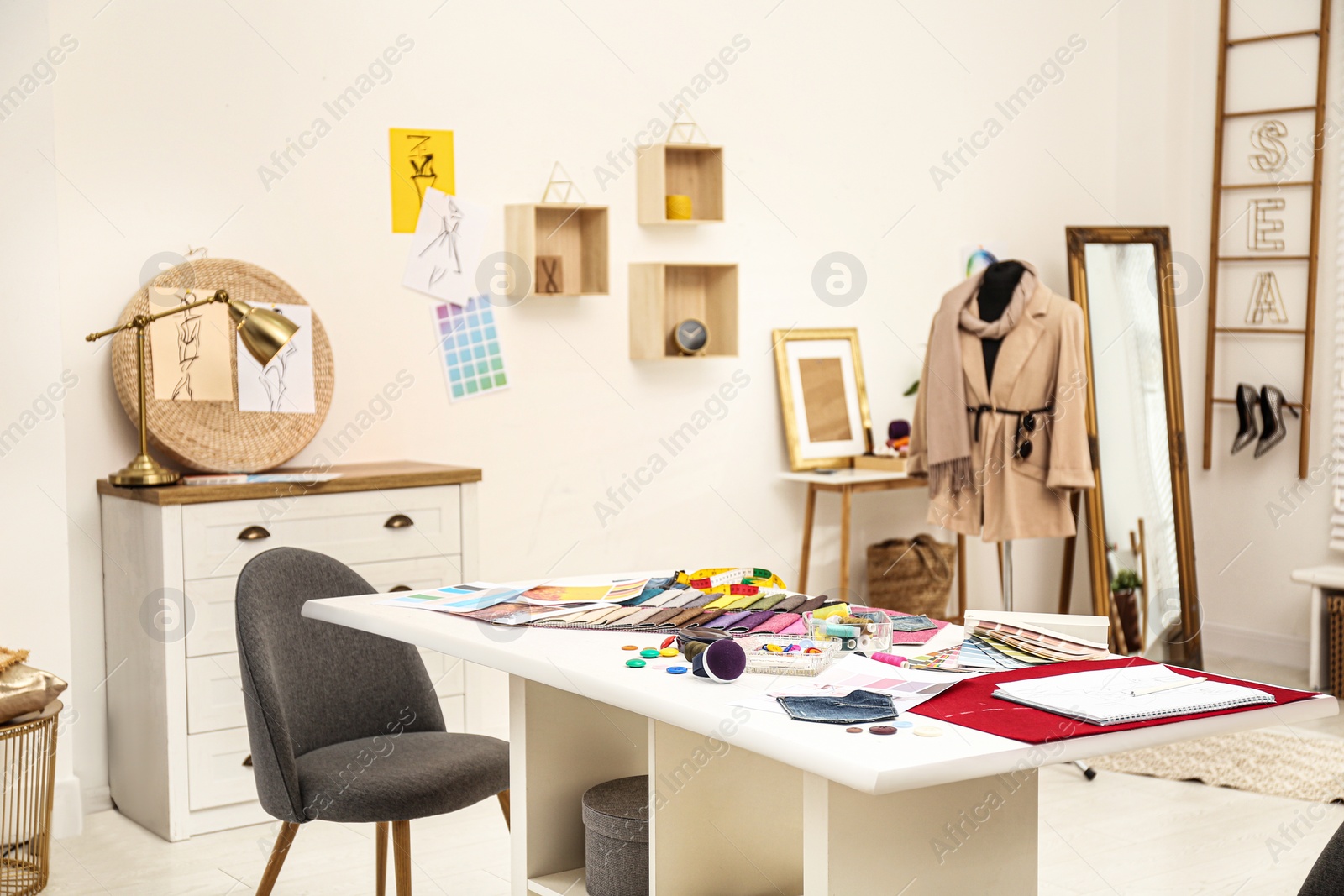 Photo of Fashion designer's workplace in studio. Creating new clothes