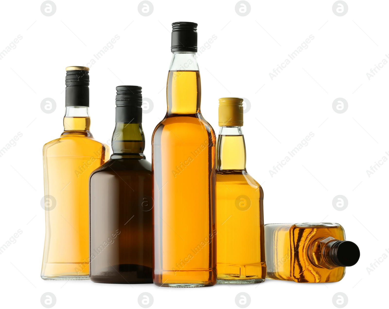 Photo of Different sorts of whiskey in glass bottles isolated on white