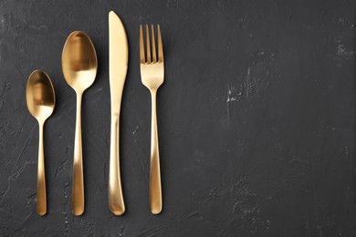 Photo of Beautiful cutlery set on black table, flat lay. Space for text