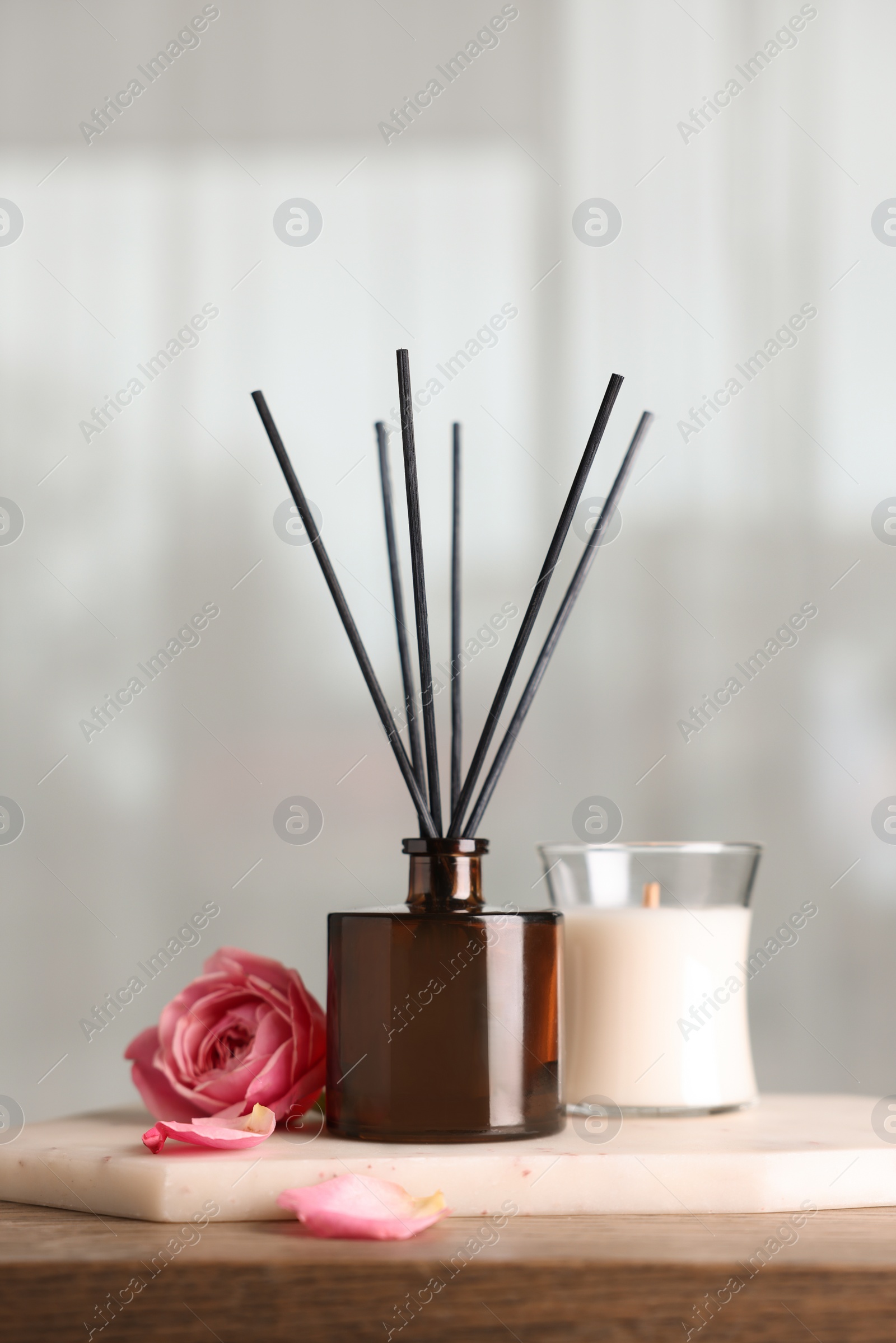 Photo of Composition with aromatic reed air freshener on wooden table