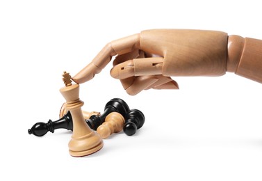 Photo of Robot touching king near fallen chess pieces isolated on white. Wooden hand representing artificial intelligence