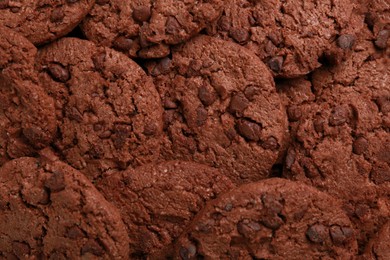 Tasty chocolate cookies as background, top view