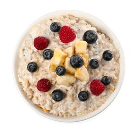 Photo of Tasty boiled oatmeal with berries and banana in bowl isolated on white, top view