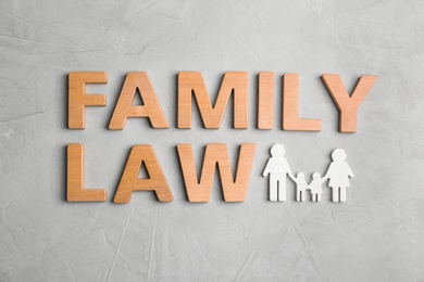 Photo of Flat lay composition with words FAMILY LAW on grey background
