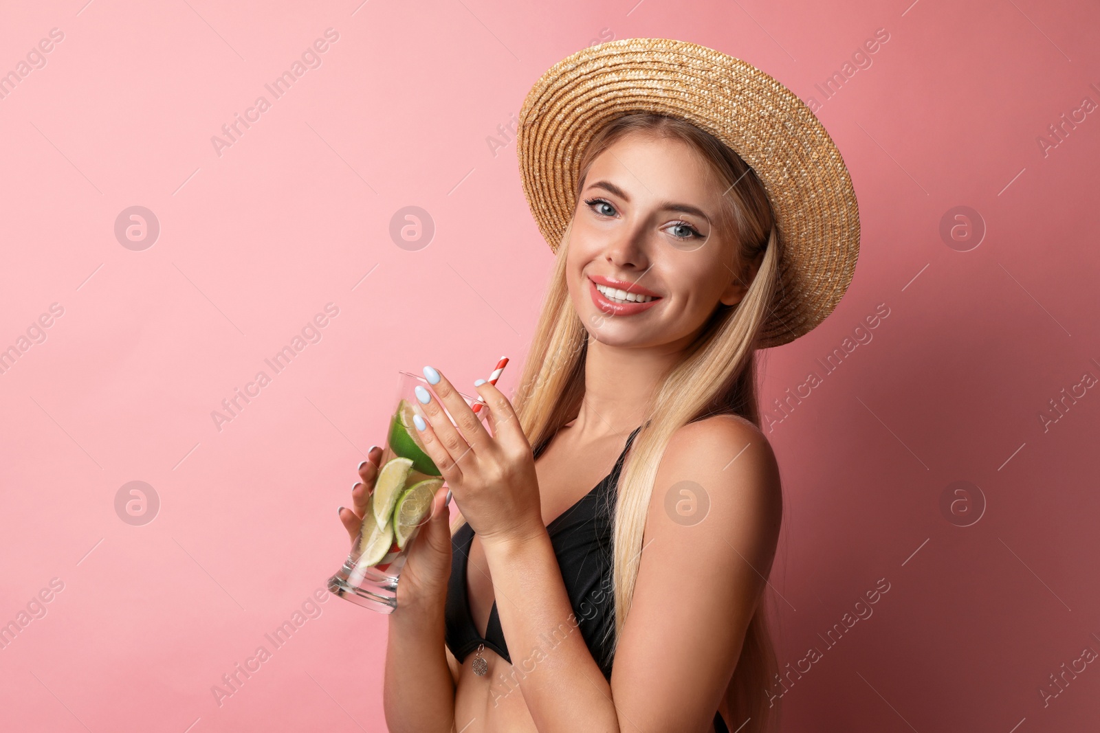 Photo of Pretty young woman wearing stylish bikini with cocktail on pink background