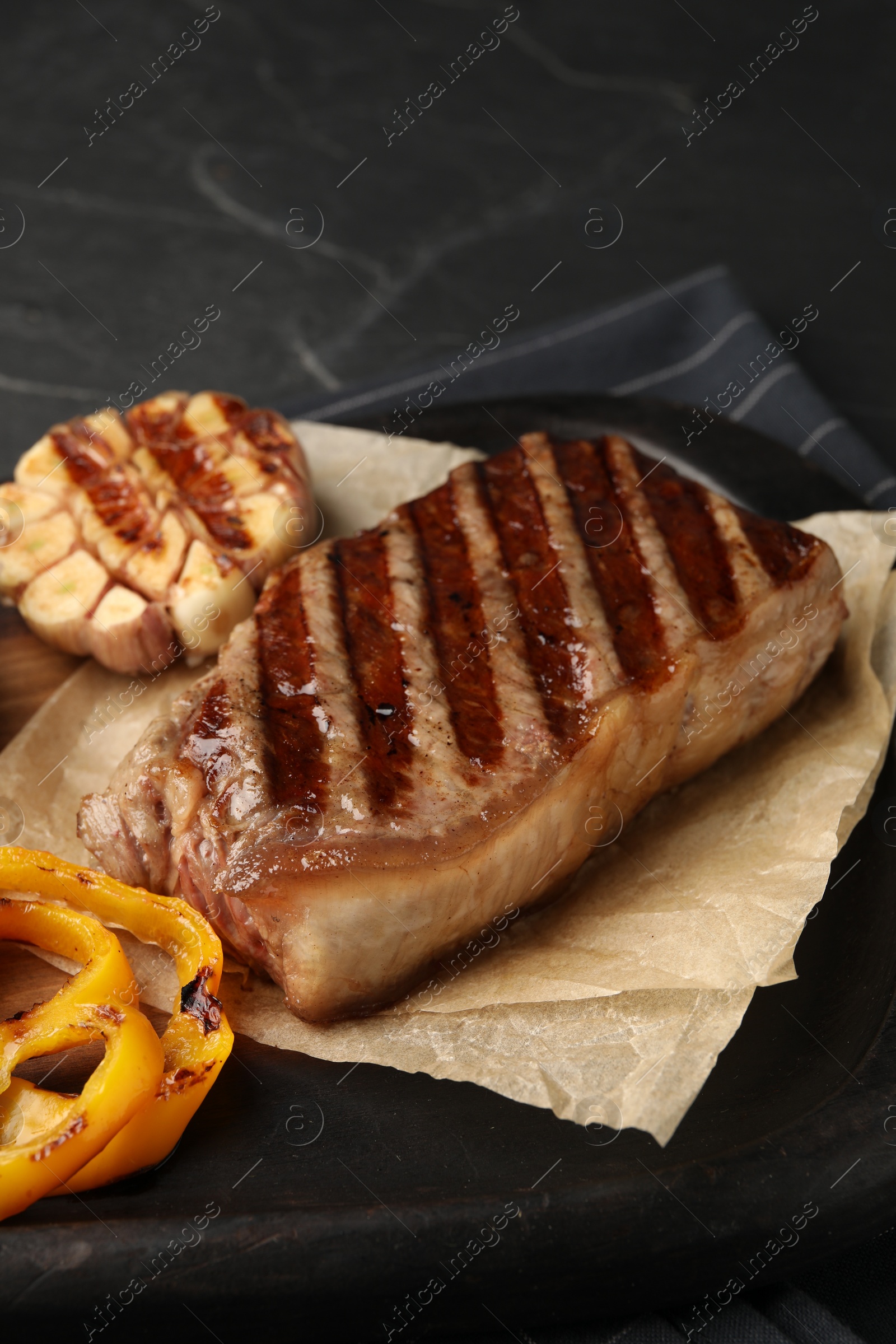 Photo of Delicious grilled beef steak with spices on table