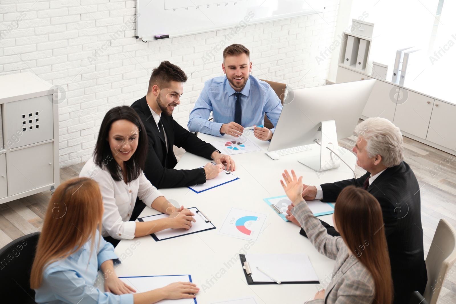 Photo of Professional business trainer working with people in office