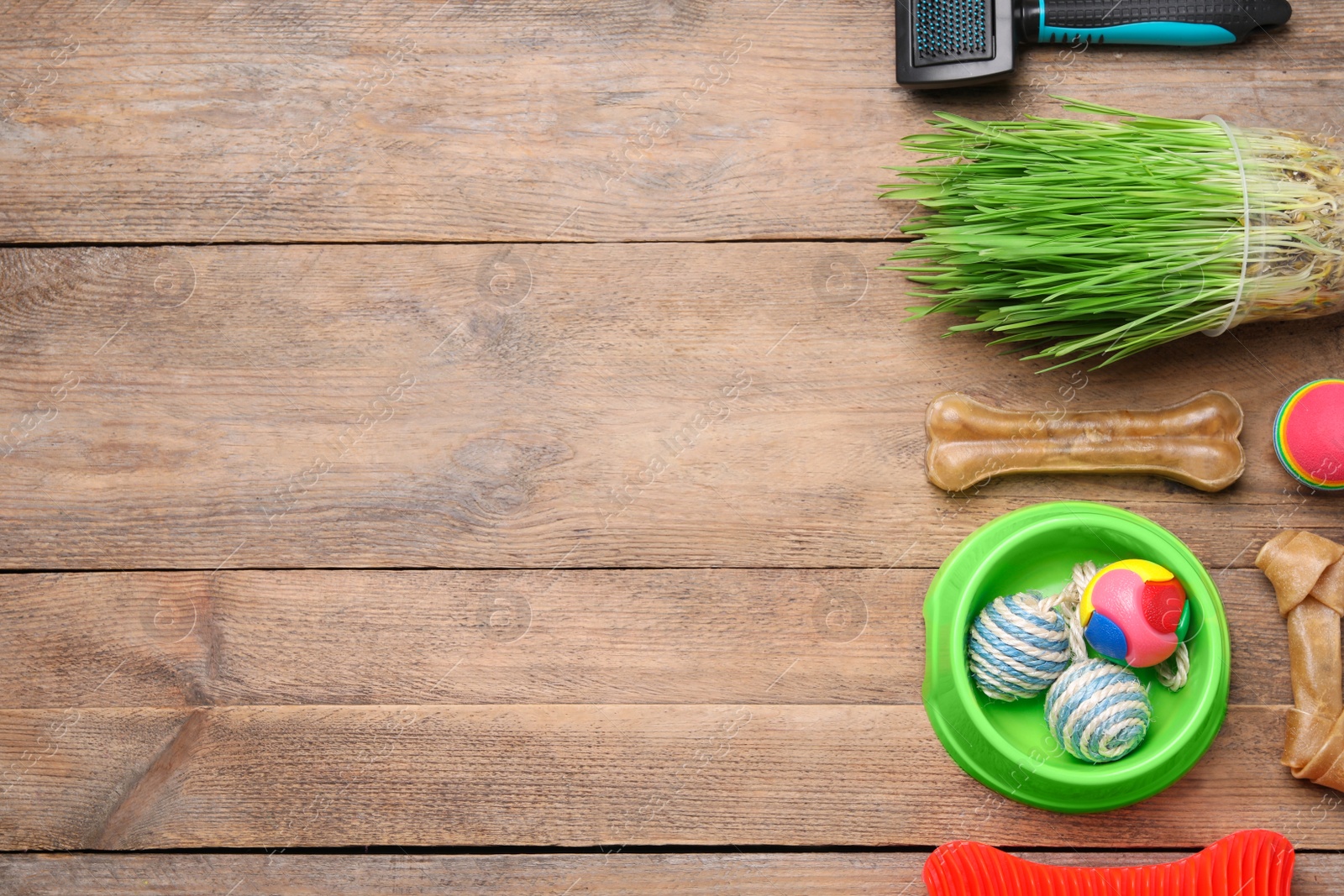 Photo of Flat lay composition with pet toys and accessories on wooden table, space for text