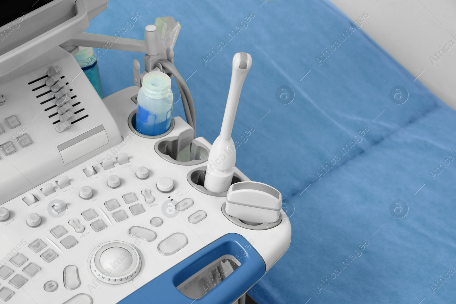 Photo of Ultrasound control panel and examination table in hospital, closeup