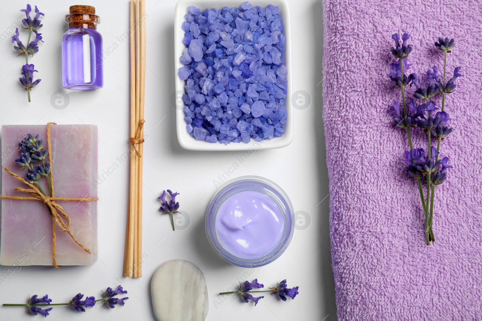 Photo of Cosmetic products and lavender flowers on white background, flat lay