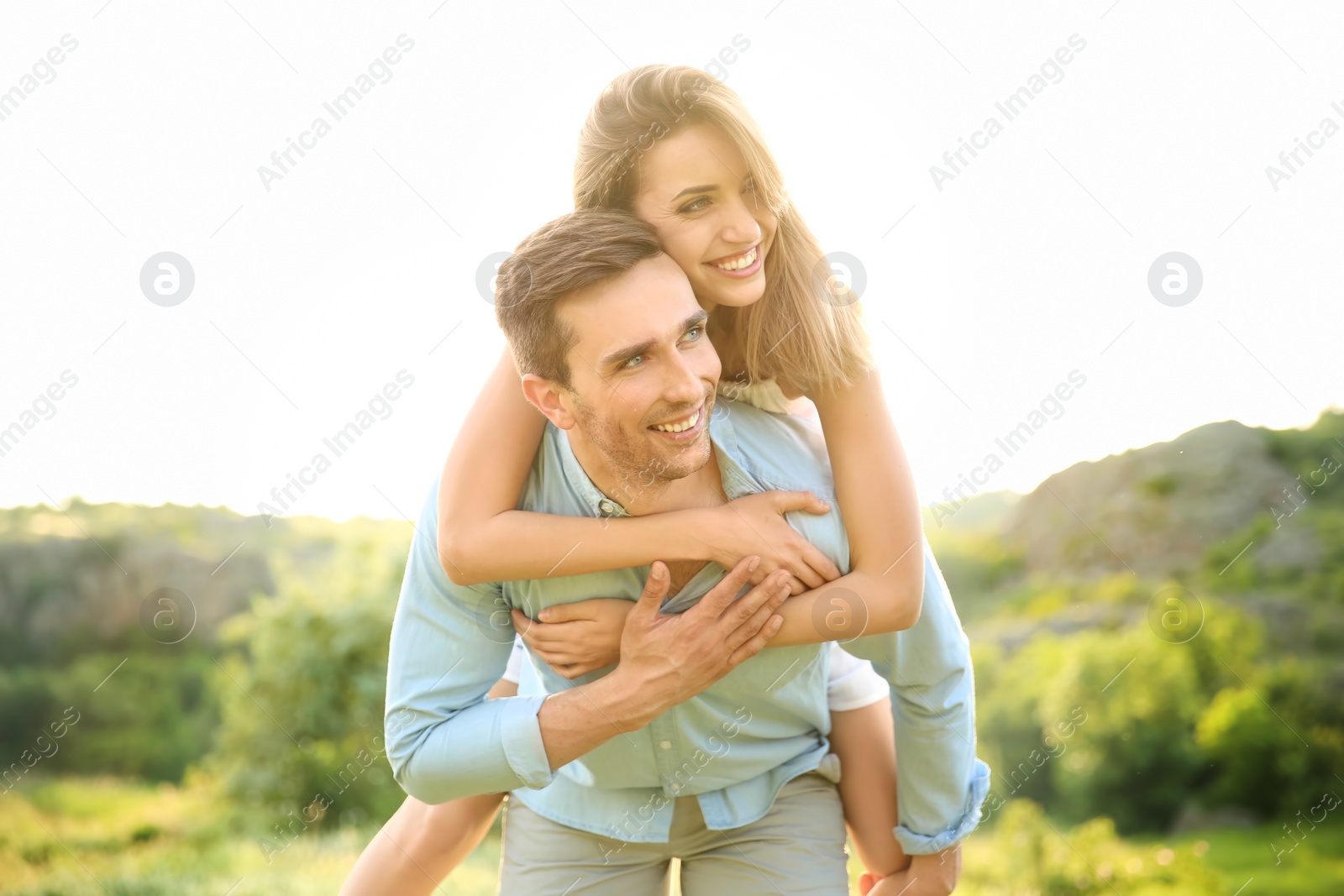 Photo of Cute young couple in love posing outdoors on sunny day