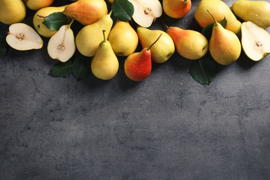 Ripe pears on grey background, top view. Space for text