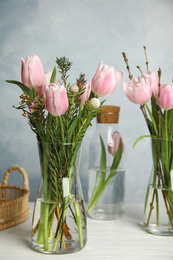 Beautiful bouquet with spring pink tulips on table