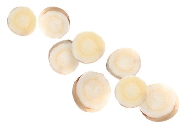 Image of Slices of fresh parsley root falling on white background