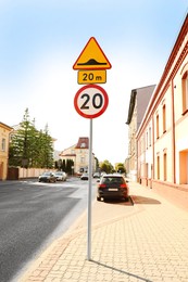 Post with different road signs on city street