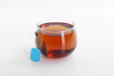 Photo of Tasty tea in cup on white background