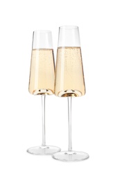 Photo of Glasses of champagne on white background. Festive drink