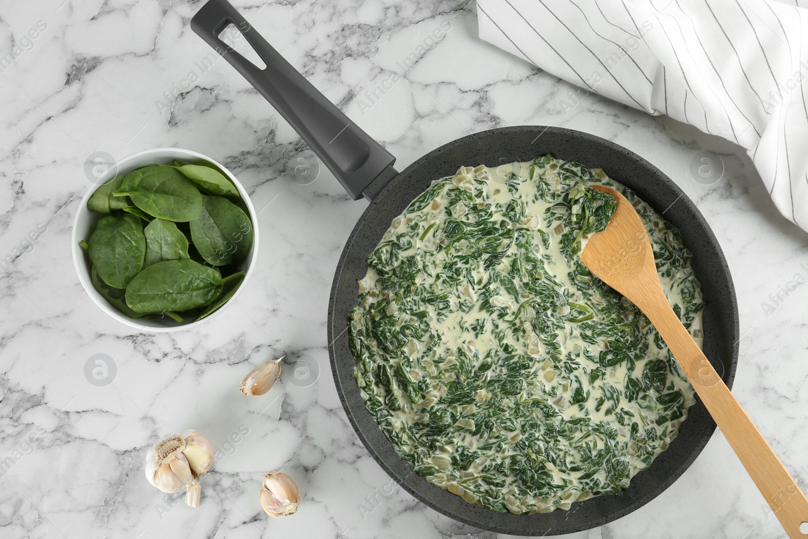 Photo of Tasty spinach dip on white marble table, flat lay