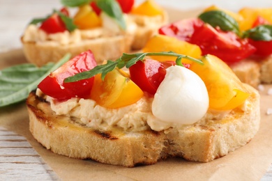 Delicious tomato bruschetta on table, closeup. Traditional Italian antipasto