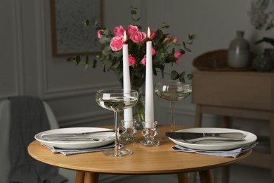 Photo of Romantic table setting with candles and flowers