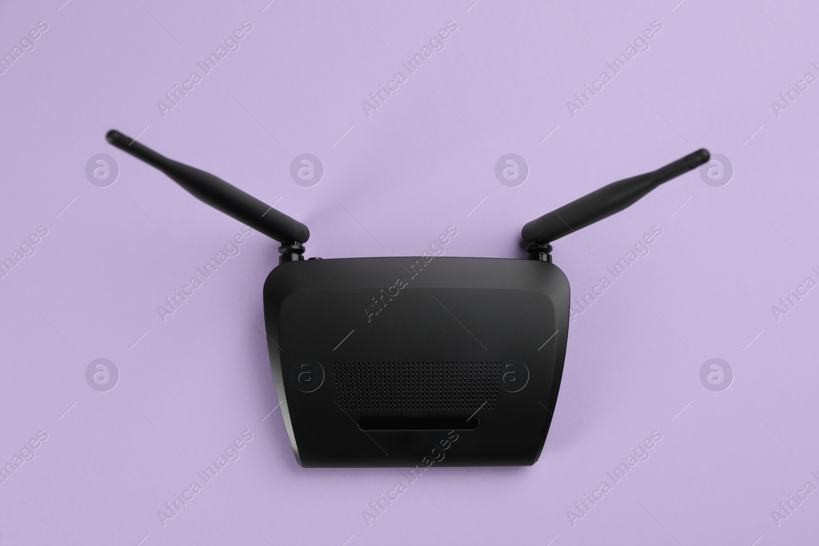 Photo of Modern Wi-Fi router on lilac background, top view