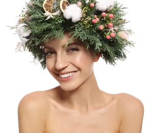 Happy young woman wearing wreath on white background