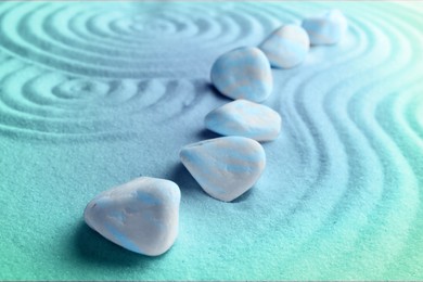 Image of Stones on sand with pattern. Zen, meditation, harmony