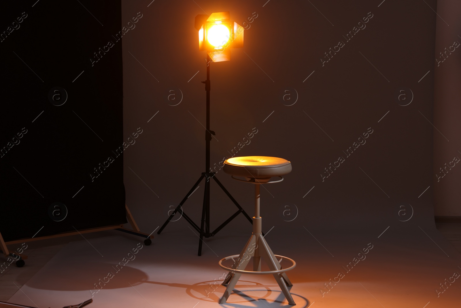 Photo of Casting call. Chair and lamp in modern studio