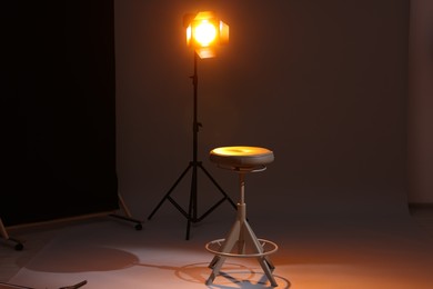 Photo of Casting call. Chair and lamp in modern studio