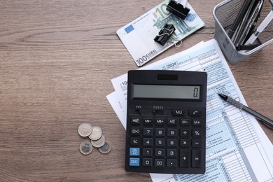 Photo of Tax accounting. Flat lay composition with calculator and documents on wooden table, space for text