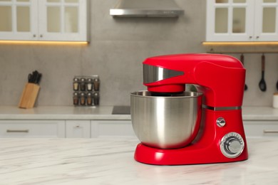 Photo of Modern red stand mixer on white marble table in kitchen, space for text