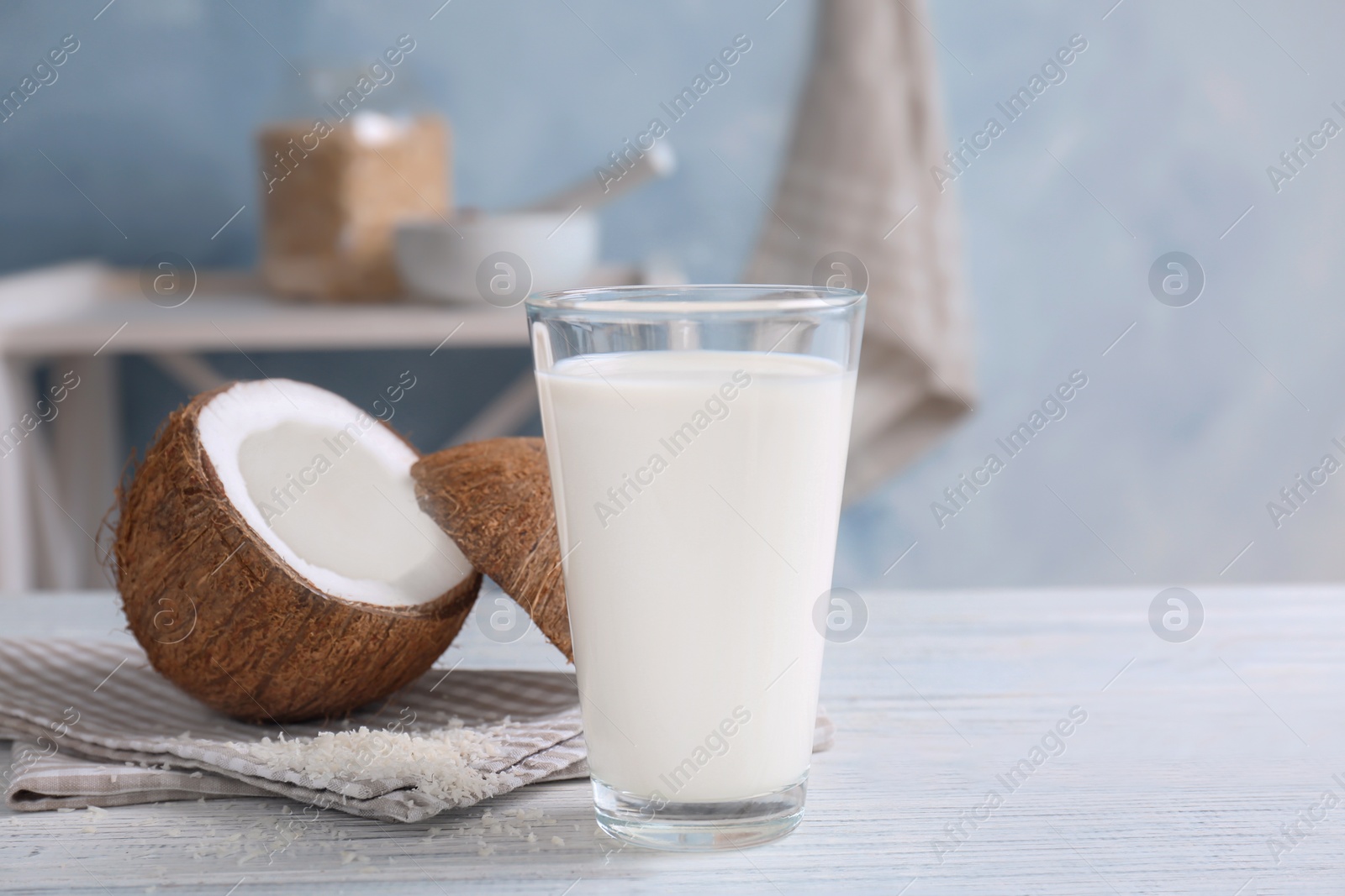 Photo of Glass with coconut milk on wooden table