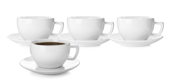 Empty ceramic cups and one with aromatic coffee on white background. Banner design