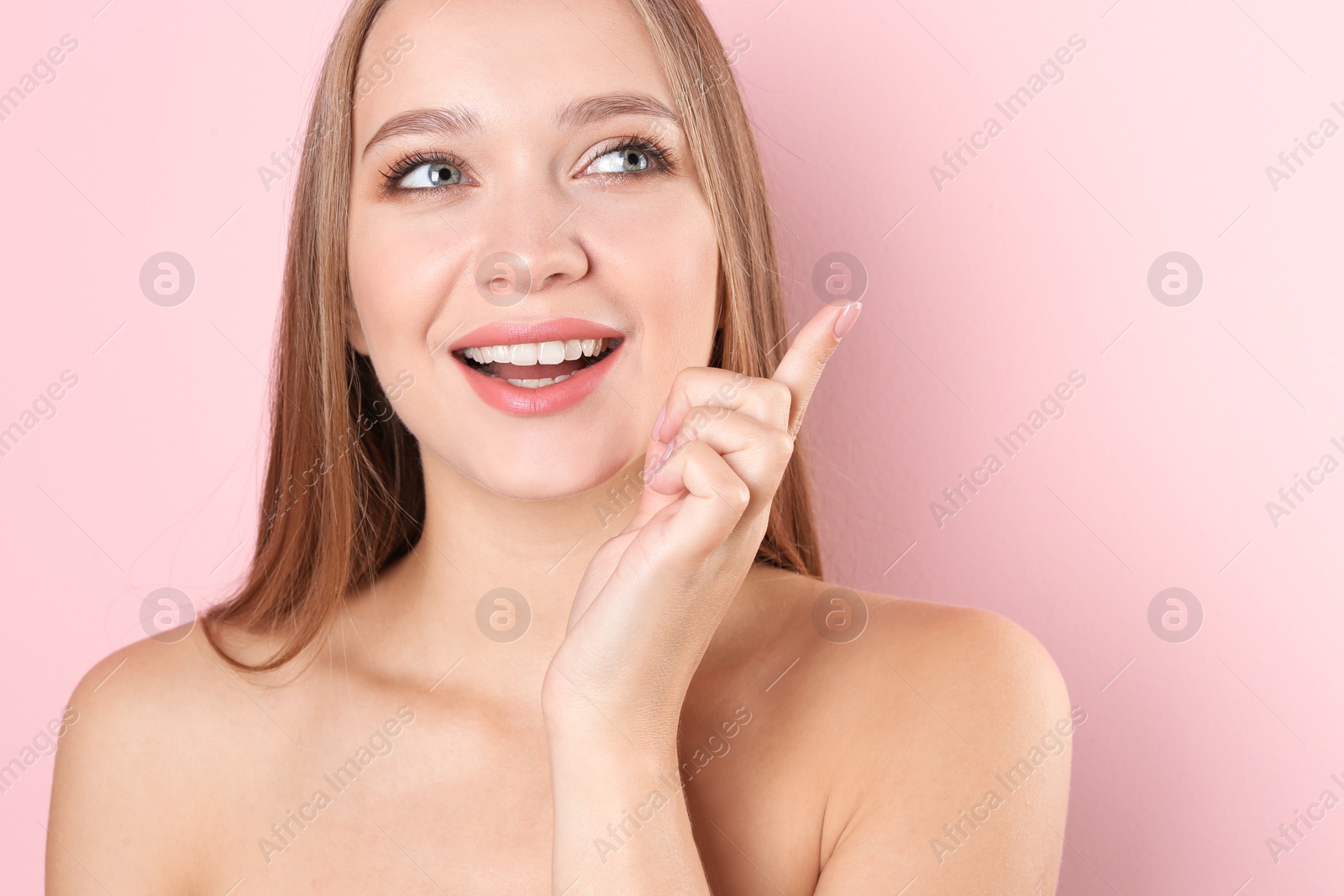 Photo of Portrait of beautiful young woman with natural makeup on color background
