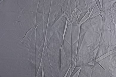 Photo of Crumpled grey fabric as background, top view