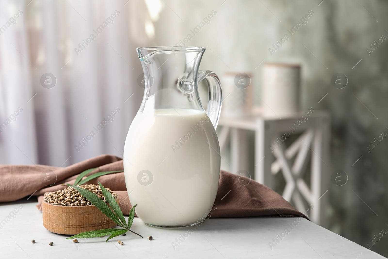 Photo of Composition with hemp milk on white table indoors