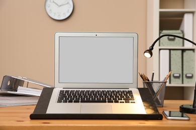 Stylish workplace with modern laptop on desk