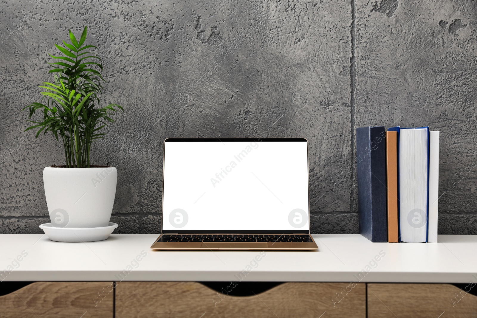 Photo of Workplace with modern laptop on white table. Mockup for design