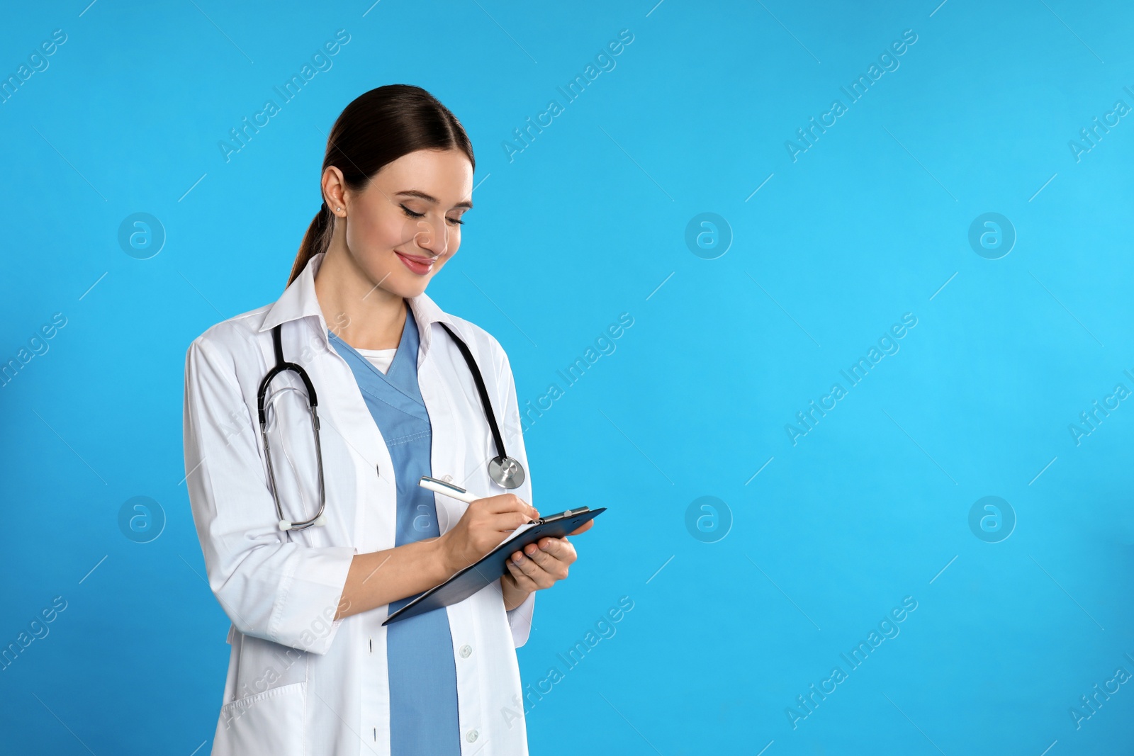 Photo of Doctor with stethoscope and clipboard on blue background. Space for text