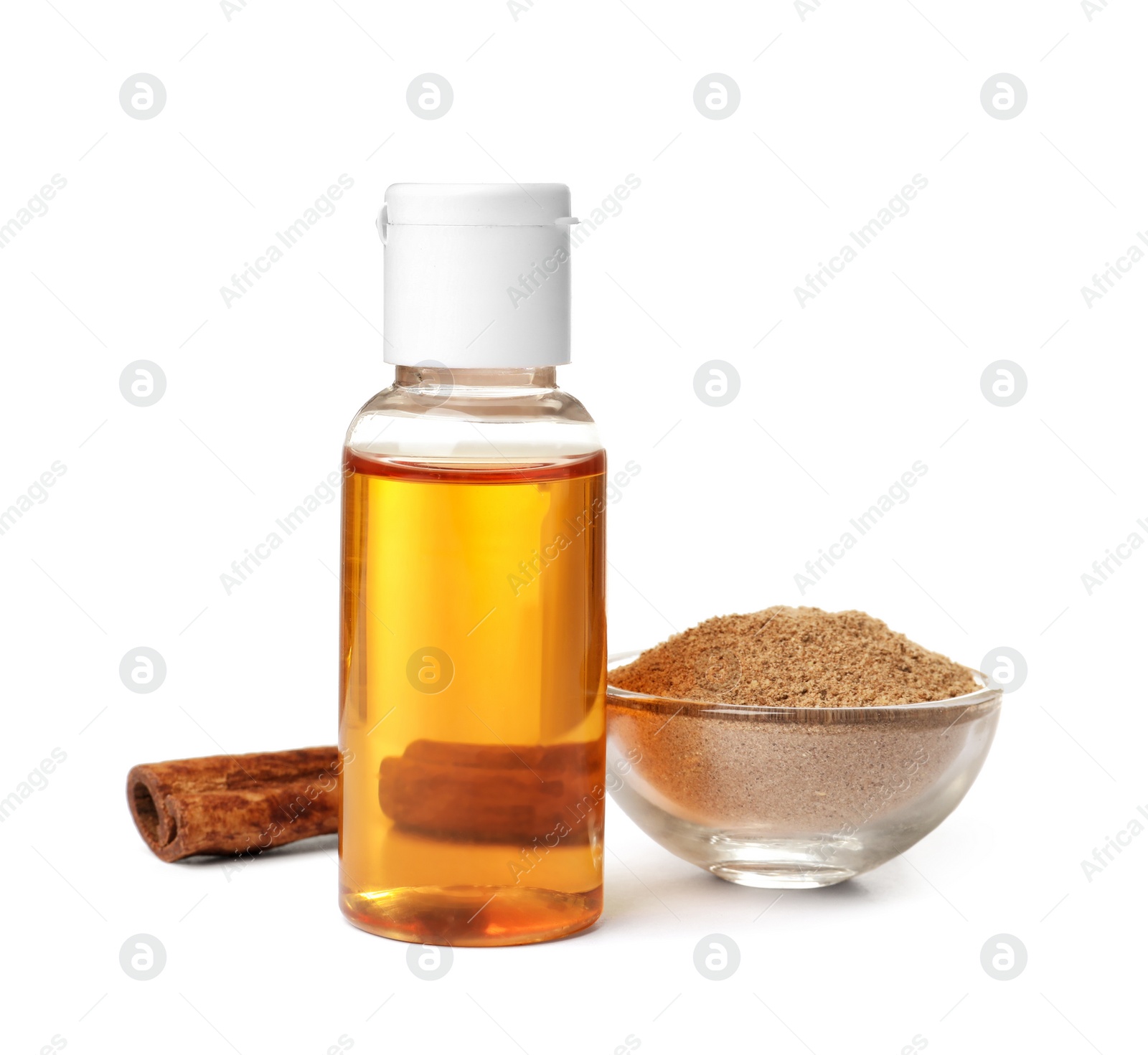 Photo of Bottle of cinnamon oil, bowl with powder and stick on white background