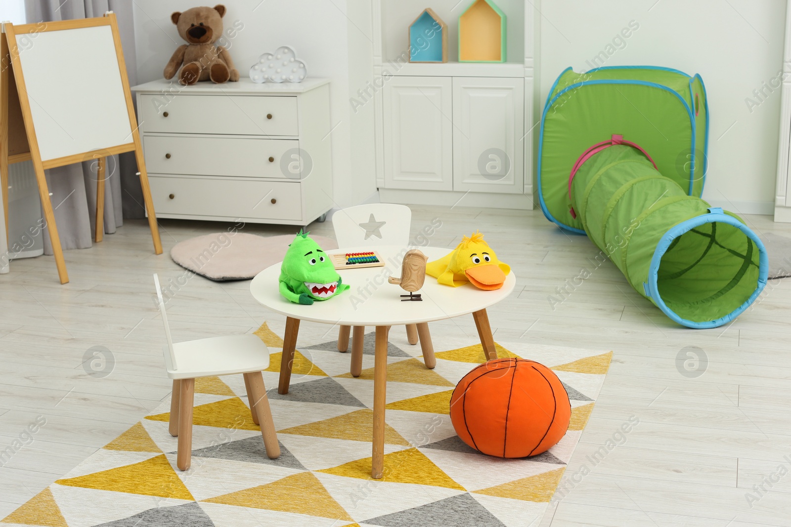 Photo of Child`s playroom with different toys and modern furniture. Stylish kindergarten interior