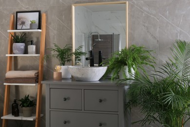 Photo of Modern bathroom interior with stylish vessel sink and beautiful green houseplants