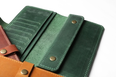 Photo of Leather wallets on white background, closeup. Stylish accessories