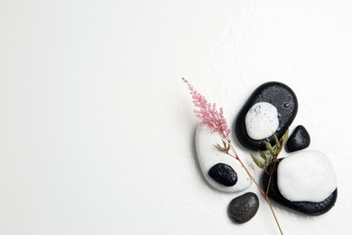 Photo of Flat lay composition with spa stones and space for text on white background