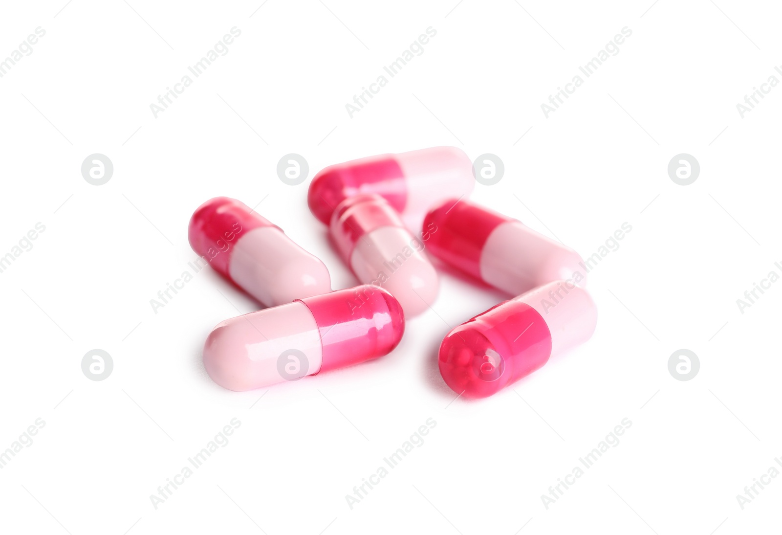 Photo of Many pink pills isolated on white. Medicinal treatment