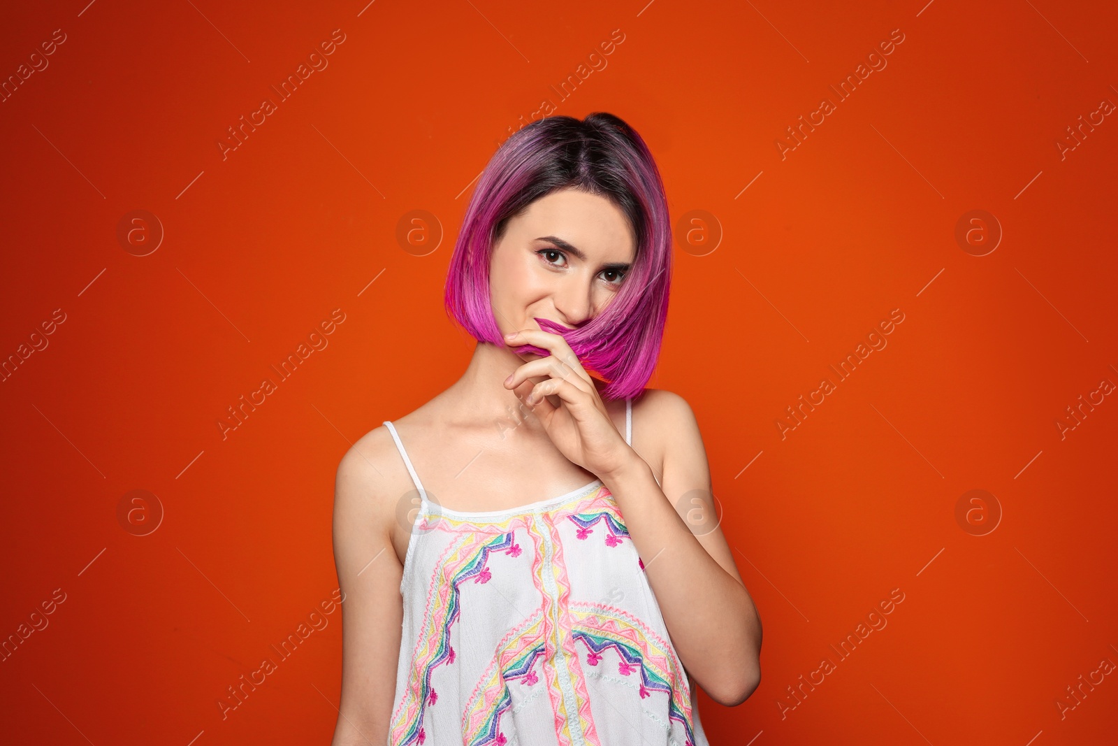 Photo of Young woman with trendy hairstyle against color background