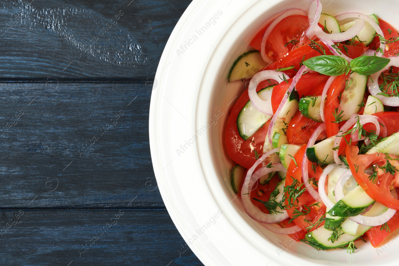 Photo of Plate with delicious fresh salad on table, top view